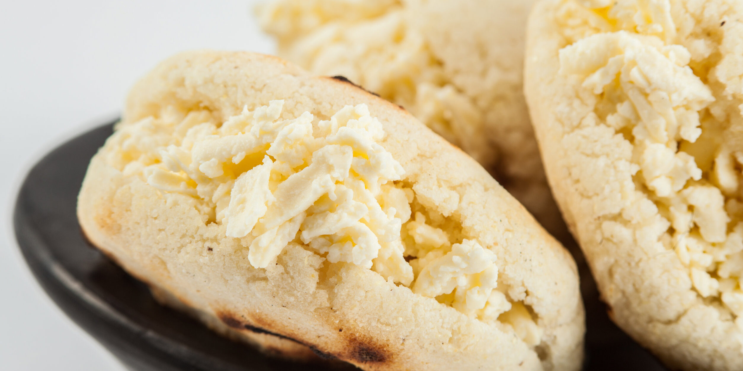 Colombian traditional white corn arepa stuffed with grated chees