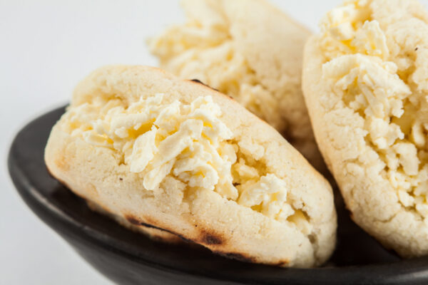Colombian traditional white corn arepa stuffed with grated chees