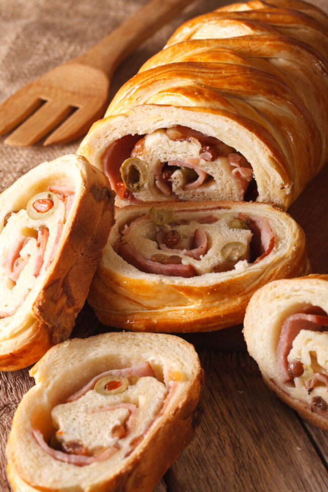 sliced bread stuffed with ham and olives close-up vertical