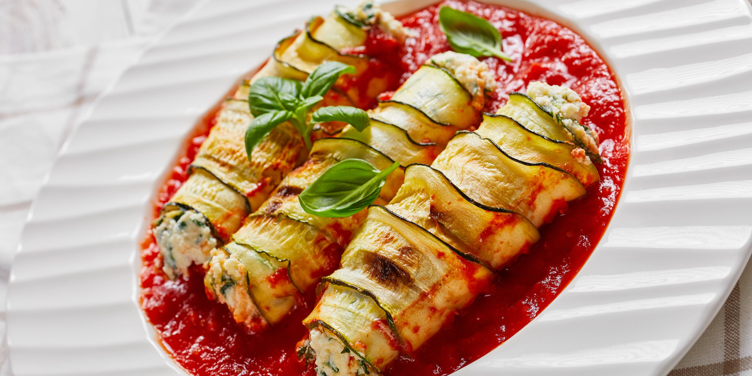 Stuffed zucchini roll-ups with soft ricotta cheese
