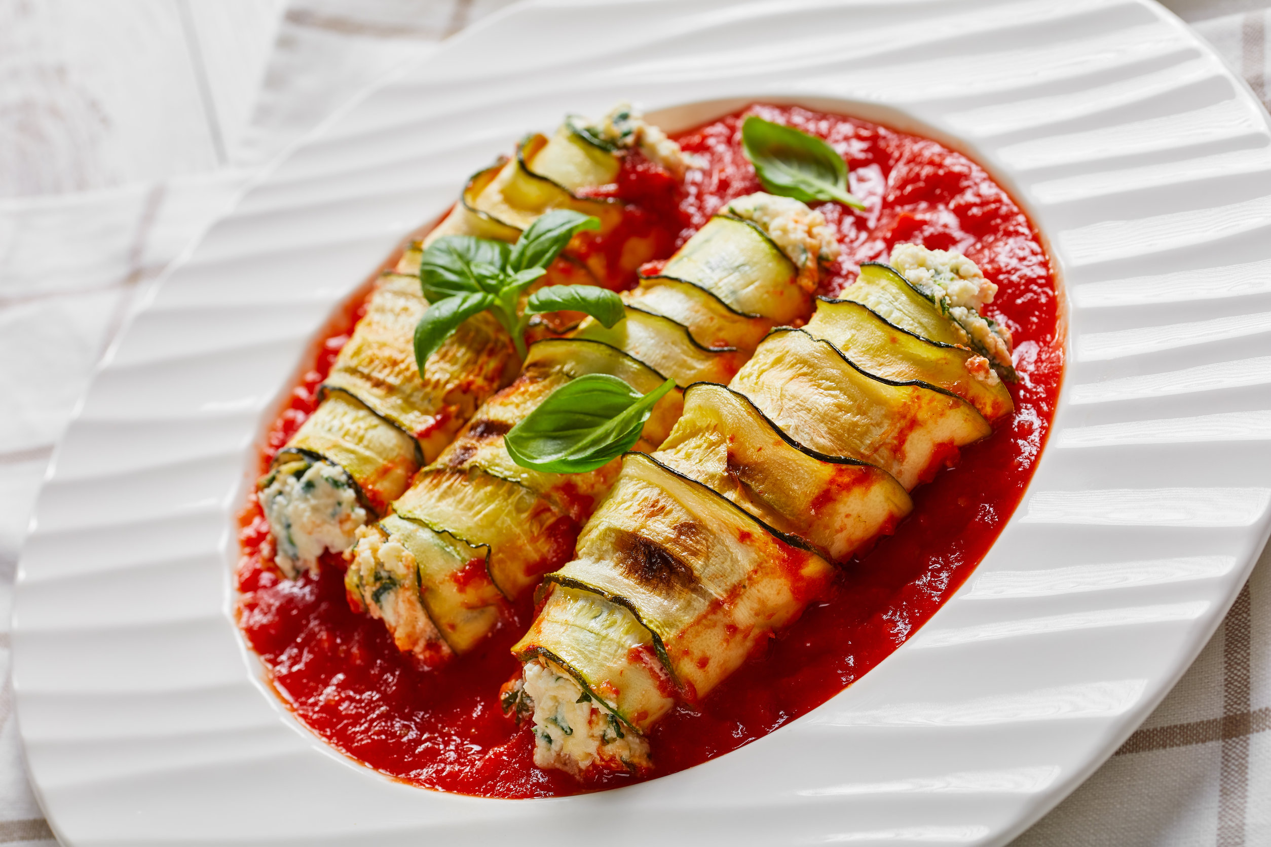 Stuffed zucchini roll-ups with soft ricotta cheese