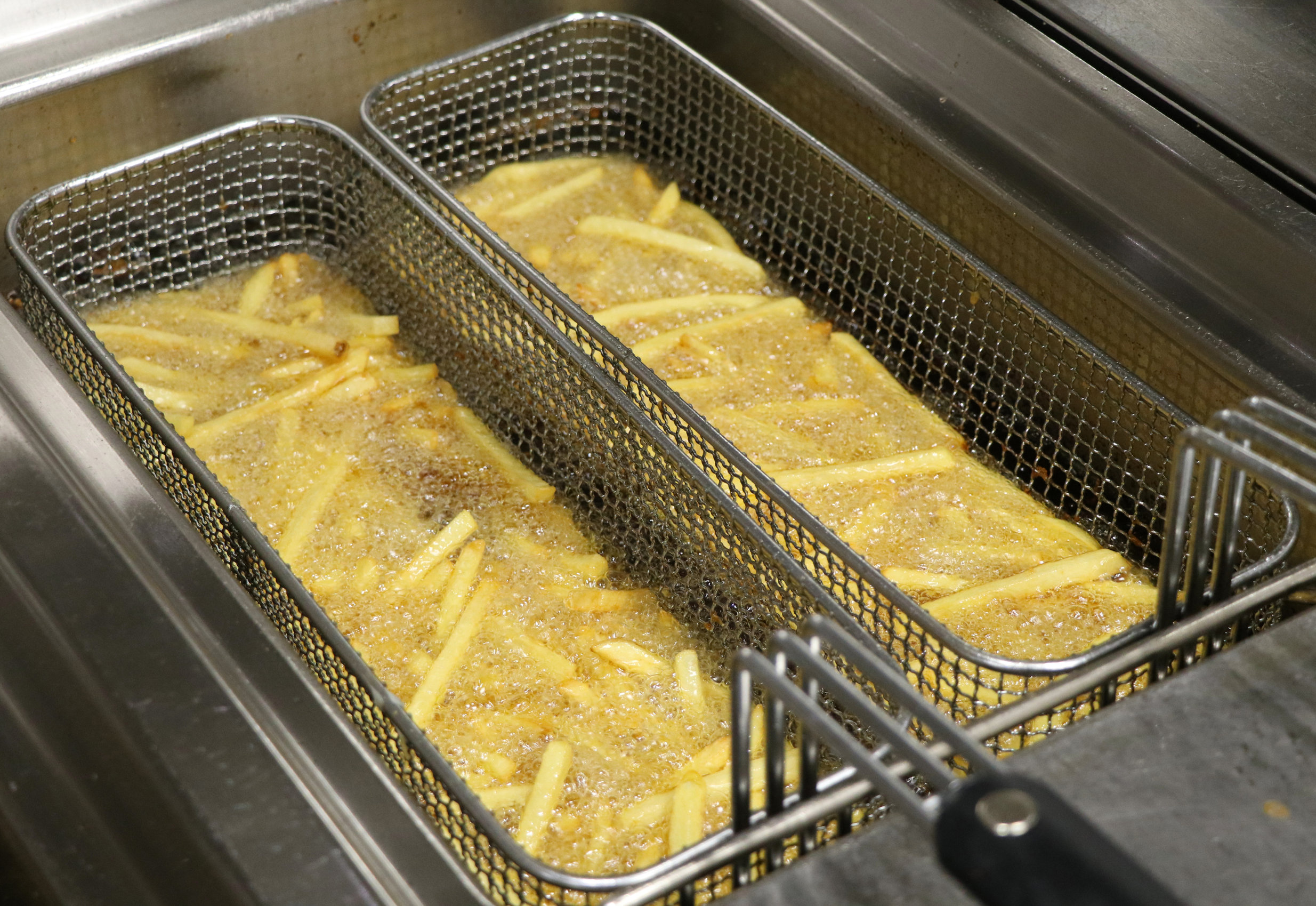 potato chicps frying in a deep fryer Wrap It Up by John Peppin, D.O.
