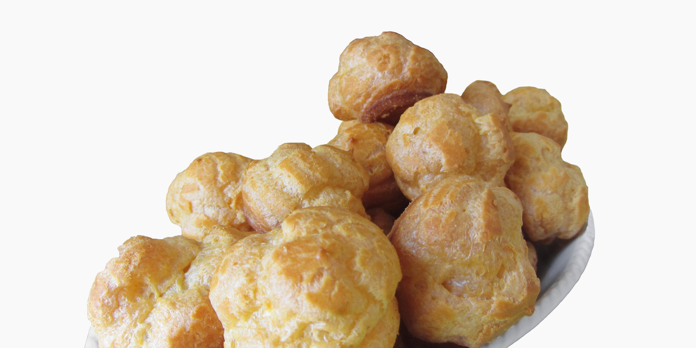 Delicious beignets composed of a shell of choux pastry isolated on white background