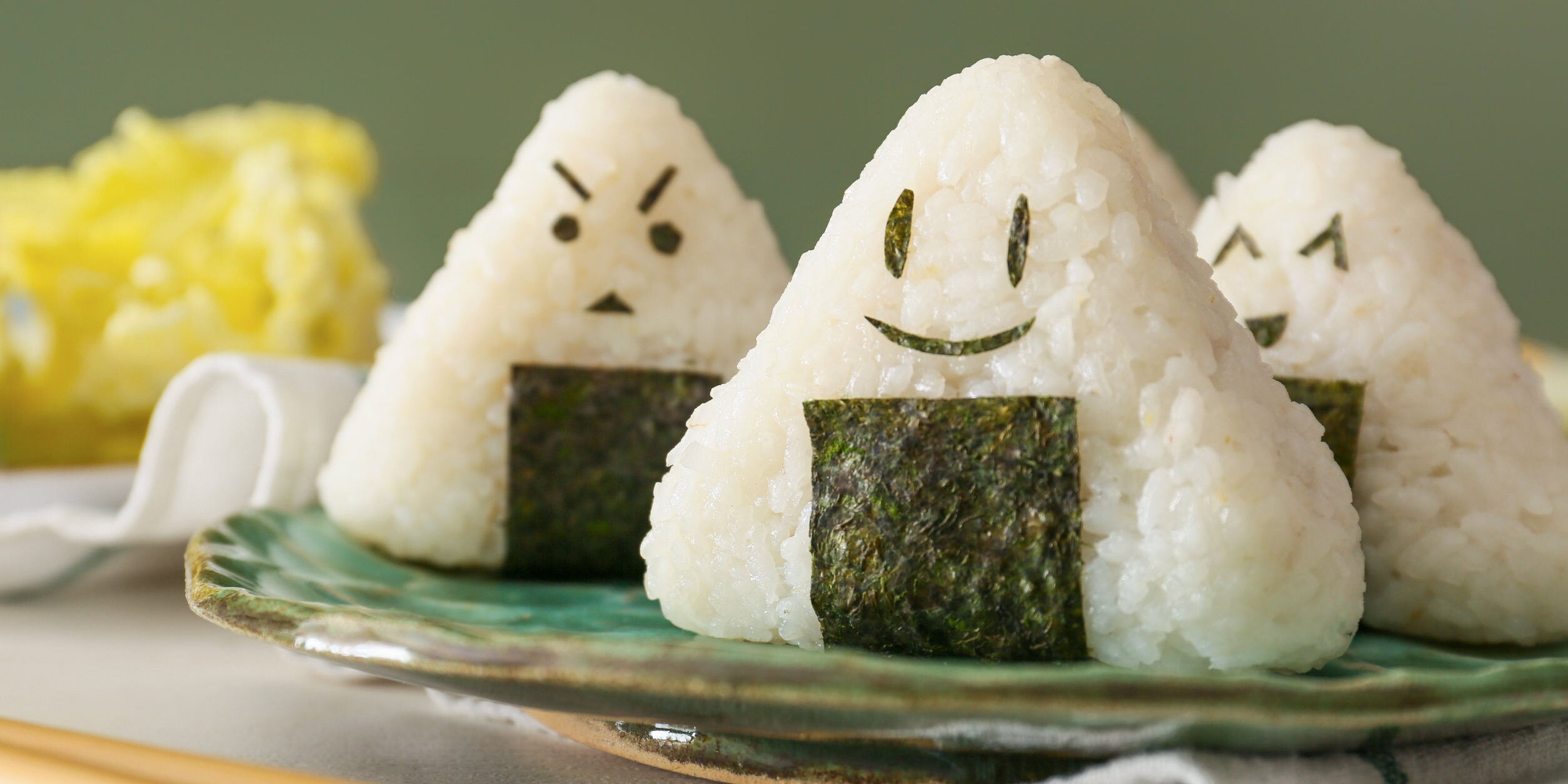 Plate with traditional Japanese onigiri on table, closeup